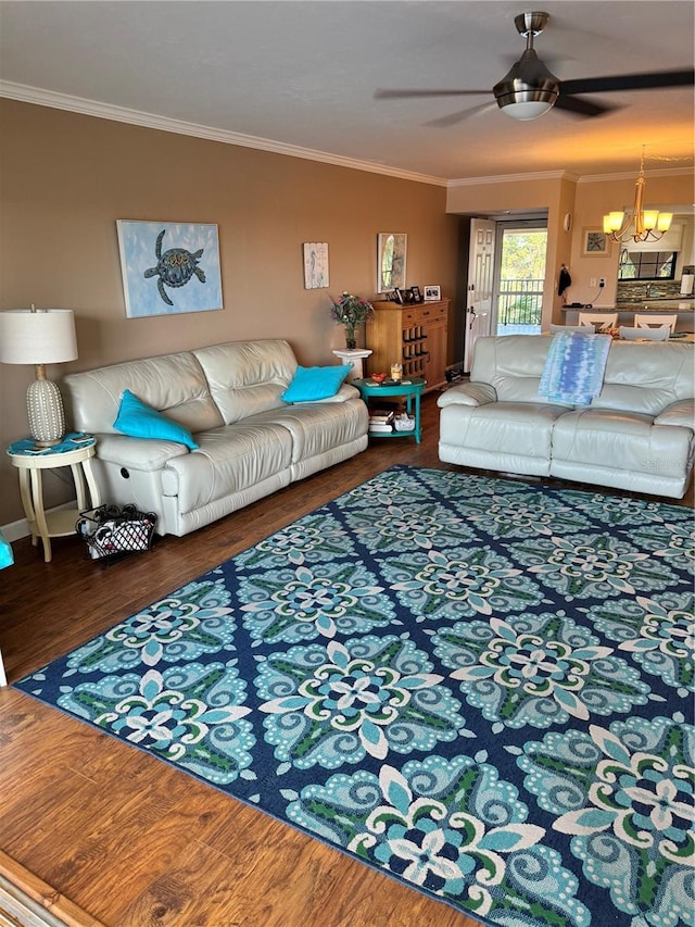 living room featuring ceiling fan with notable chandelier, wood-type flooring, and ornamental molding