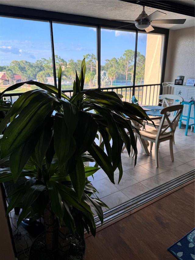 sunroom / solarium featuring ceiling fan