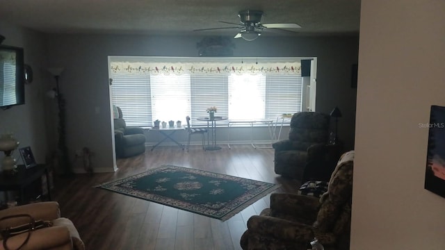 living room featuring ceiling fan and wood-type flooring