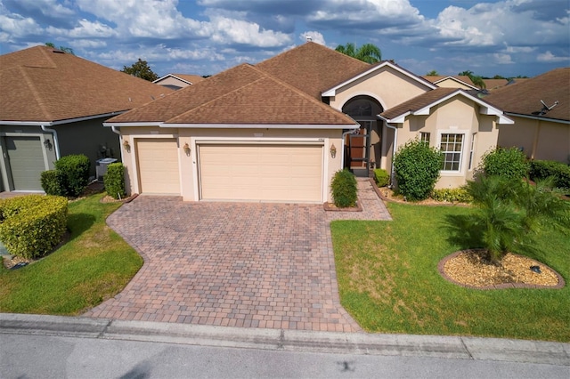 ranch-style home with a front lawn and a garage