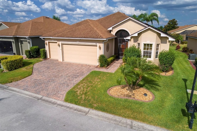 single story home featuring a front yard, a garage, and central AC unit