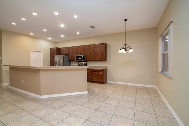 kitchen with light tile patterned floors, a notable chandelier, and stainless steel appliances