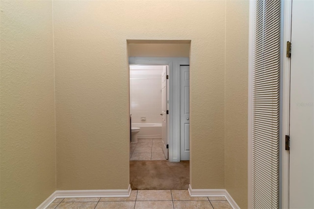 hall featuring light tile patterned flooring