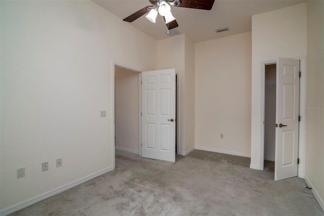 unfurnished bedroom with light carpet and ceiling fan