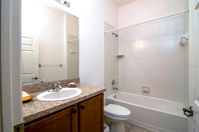 full bathroom featuring toilet, vanity, tiled shower / bath combo, and tile patterned flooring