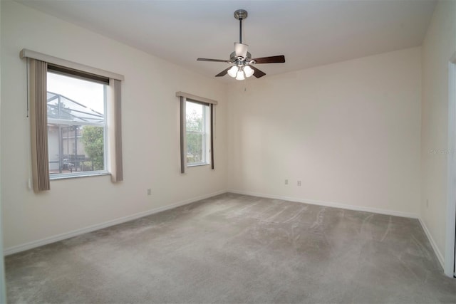 carpeted spare room with ceiling fan