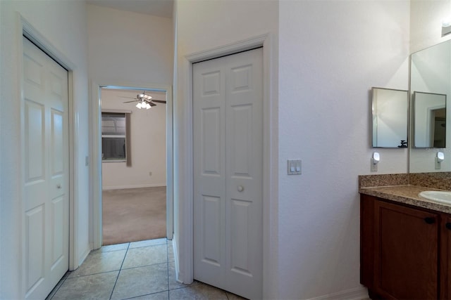 bathroom with ceiling fan, vanity, and tile patterned flooring