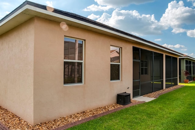 view of side of home featuring a yard