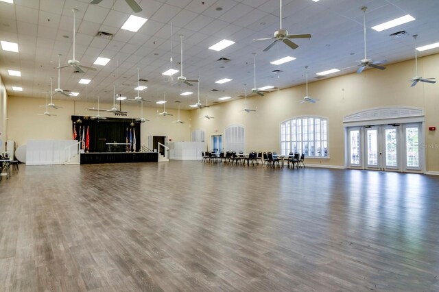 workout room featuring a high ceiling and dark hardwood / wood-style floors