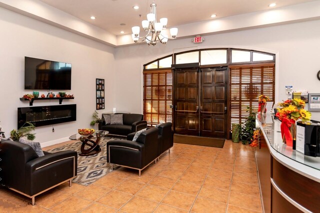 tiled living room featuring a chandelier