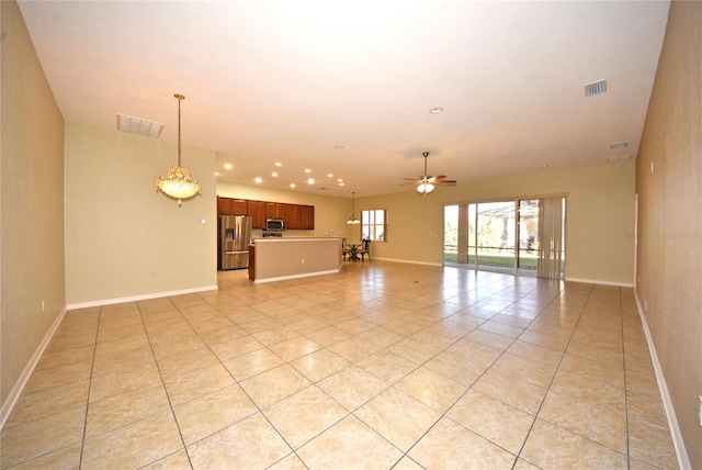 unfurnished living room with ceiling fan and light tile patterned flooring