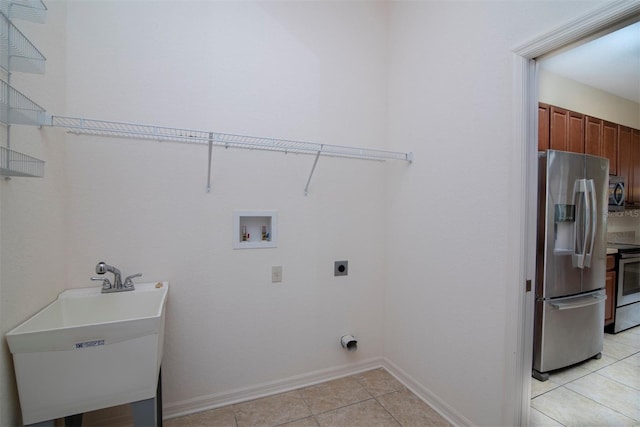 laundry area with washer hookup, light tile patterned floors, sink, and hookup for an electric dryer