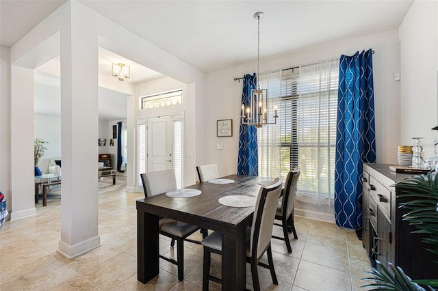 dining space featuring light tile patterned floors and a chandelier