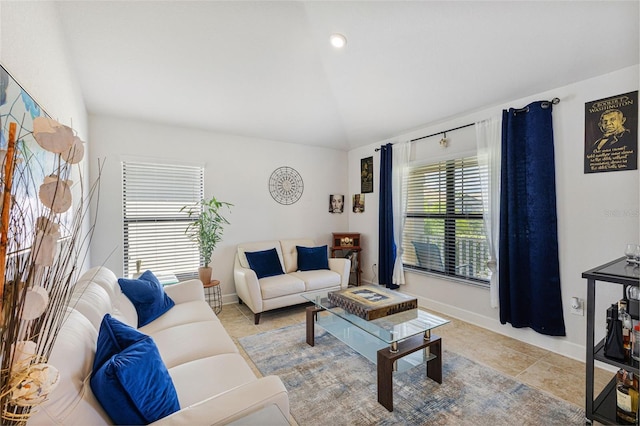 tiled living room featuring lofted ceiling