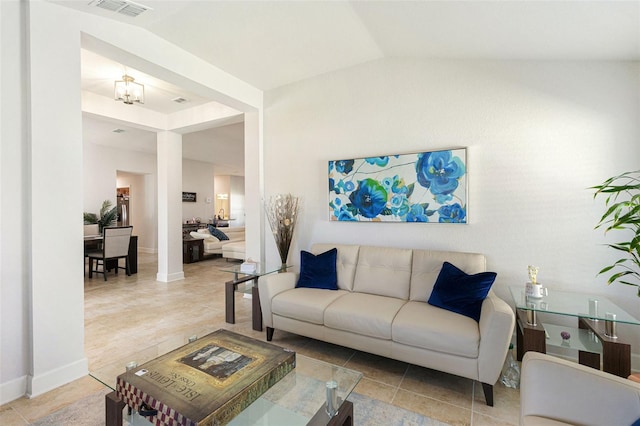 living room with tile patterned flooring, a notable chandelier, and vaulted ceiling