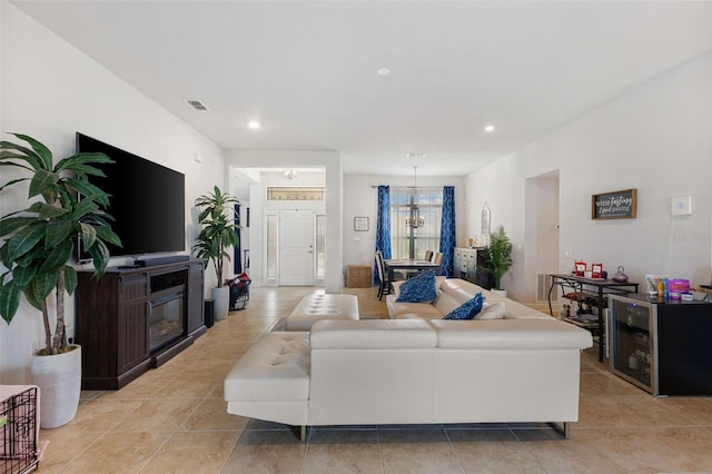 tiled living room featuring a chandelier