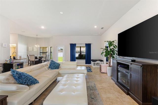 tiled living room featuring an inviting chandelier and beverage cooler