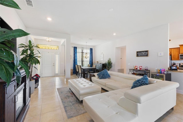 living room featuring a chandelier and light tile patterned floors