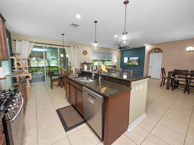 kitchen featuring decorative light fixtures, light tile patterned floors, visible vents, appliances with stainless steel finishes, and a sink