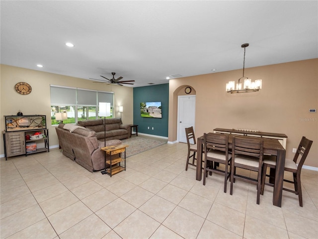 living area with light tile patterned floors, recessed lighting, baseboards, and ceiling fan with notable chandelier