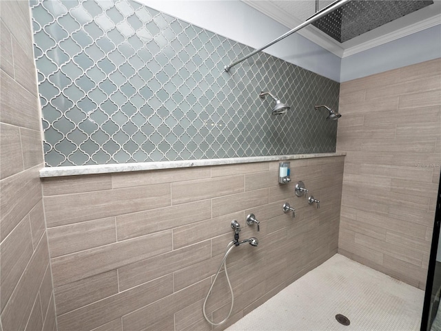 full bath featuring ornamental molding and a tile shower