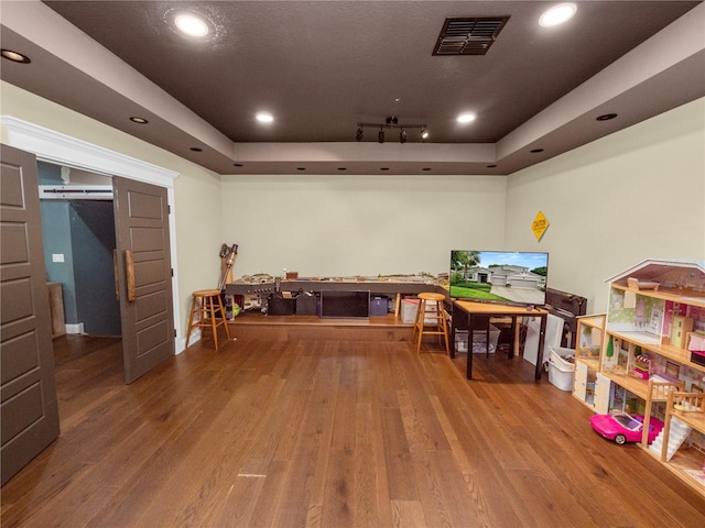 game room with wood finished floors, a raised ceiling, visible vents, and recessed lighting