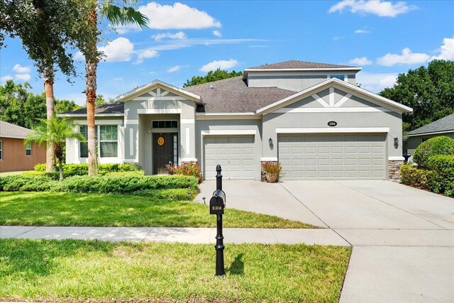 view of front of property with a garage and a front yard