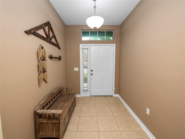 foyer featuring light tile patterned floors and baseboards