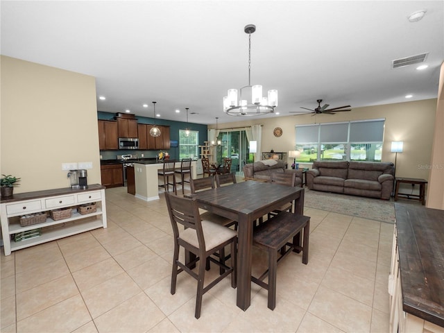 dining space featuring light tile patterned floors, ceiling fan with notable chandelier, visible vents, and recessed lighting