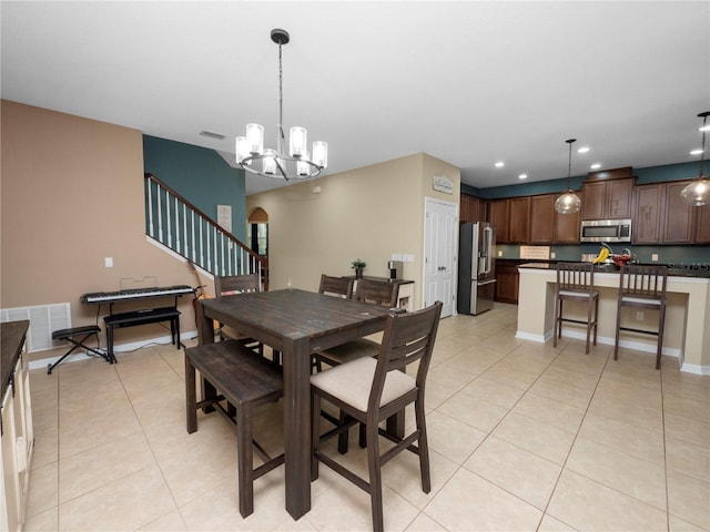 dining room with arched walkways, light tile patterned floors, visible vents, and recessed lighting