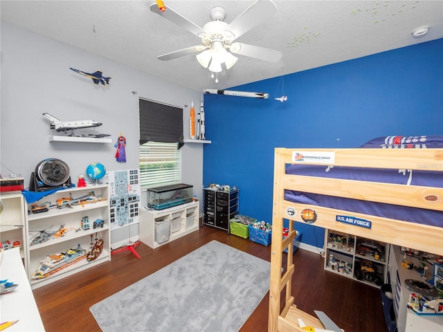 bedroom featuring a textured ceiling, a ceiling fan, and wood finished floors