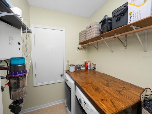 clothes washing area with laundry area, independent washer and dryer, and light tile patterned floors