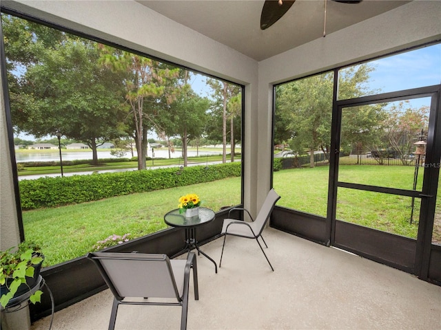 unfurnished sunroom featuring a ceiling fan