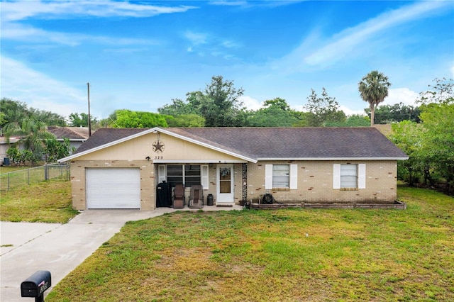 ranch-style house featuring a garage and a front lawn