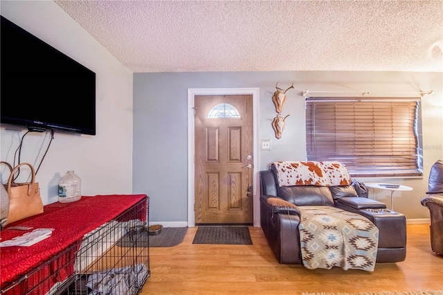 entryway with a textured ceiling and hardwood / wood-style floors