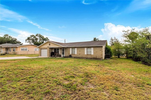 ranch-style house with a front lawn, a garage, and central AC unit