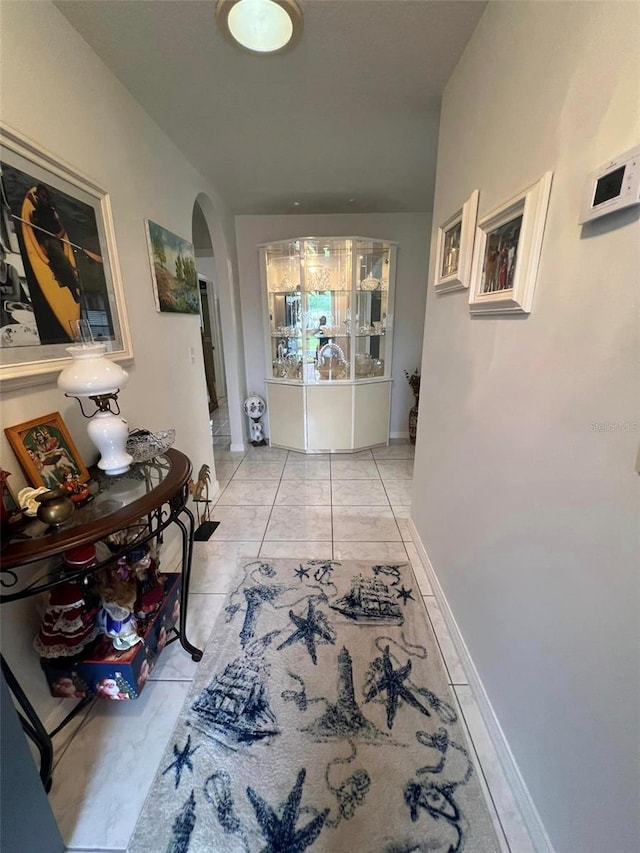 hall with light tile patterned floors