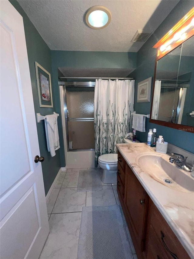 full bathroom featuring vanity, bath / shower combo with glass door, a textured ceiling, and toilet