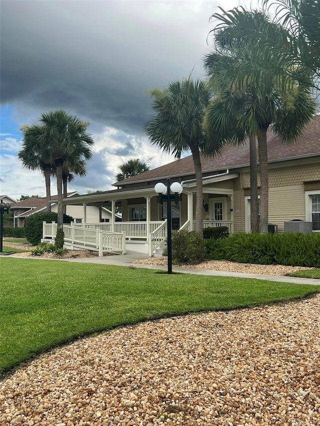 view of front of property with a front yard and a porch