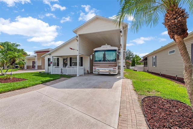 view of front of house with a porch, concrete driveway, and a front yard