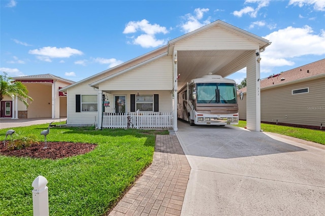 view of front of property with a carport, a front yard, and concrete driveway