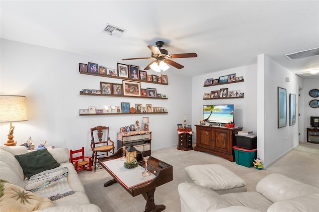 living room featuring ceiling fan and light colored carpet