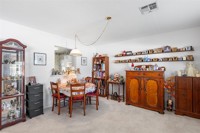 dining area with light colored carpet