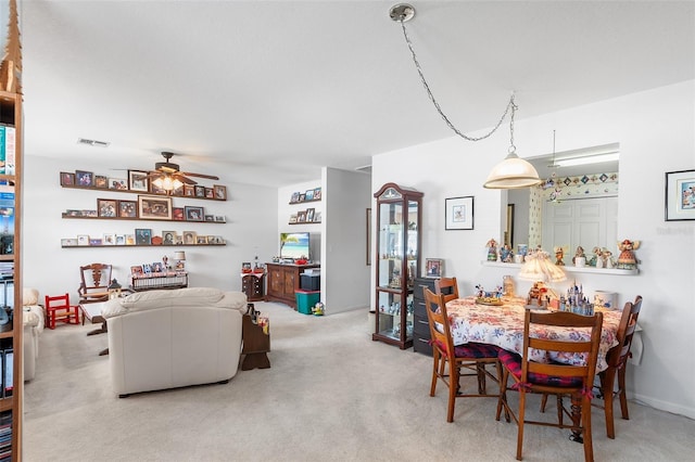 carpeted dining space featuring ceiling fan