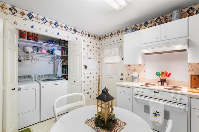 kitchen with white cabinets, light tile patterned floors, electric range, and washing machine and clothes dryer