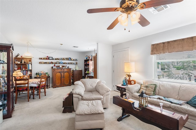 living room with ceiling fan and light colored carpet