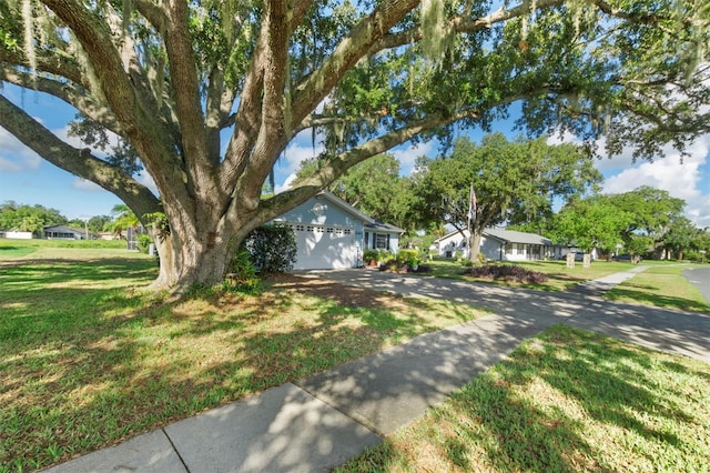 view of front of property with a garage and a front lawn