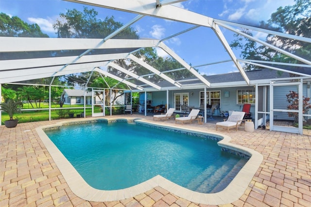 view of swimming pool featuring a patio area and glass enclosure