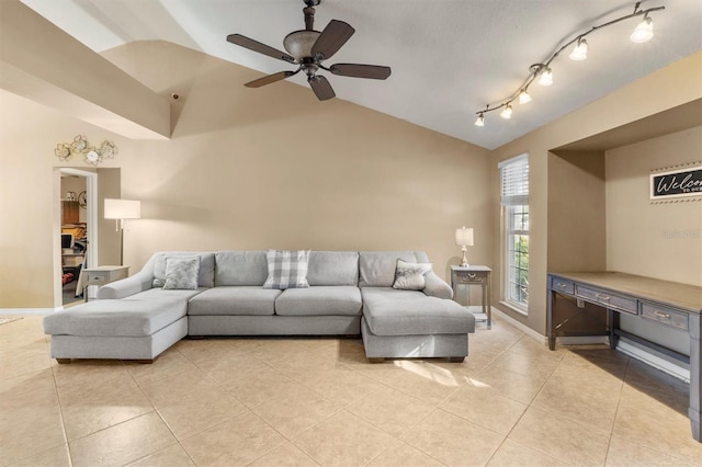 tiled living room with ceiling fan, vaulted ceiling, and track lighting