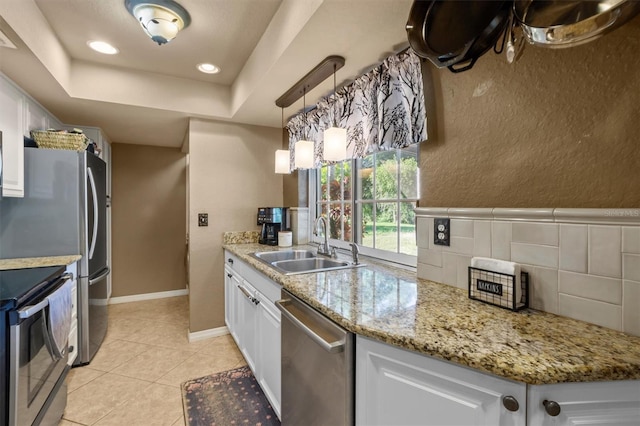 kitchen featuring sink, white cabinets, backsplash, and stainless steel dishwasher